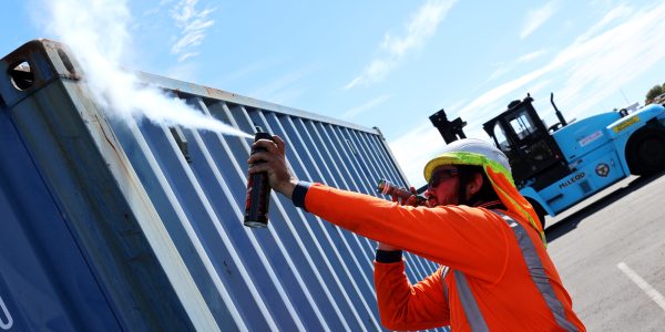 MPI-approved-AP-sea-biosecurity-training AP spraying cobwebs on sea container