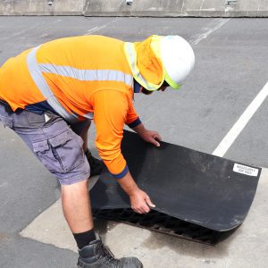 TF staff member covering drain